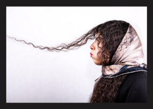 Hana is 18 years old. She is in 12th grade studying graphics. Her Family and most of her friends have asked her not to cut her hair. Hana says that people outside describe her hair using phrases like telephone wire, sheep, and spaghetti. She, however, tries to laugh it off. Her name is Hanieh in her ID card, but she has decided to change it to Hana.